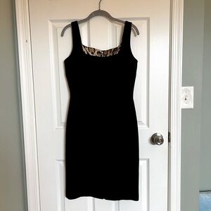 Dolce & Gabbana • knee-length black dress • cheetah print lining • back slit